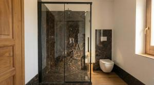 a glass shower in a bathroom with a toilet at Casa Ereva in Bagnoli Irpino