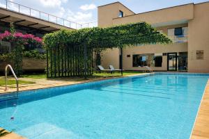 a swimming pool in front of a building at DoubleTree by Hilton Nairobi in Nairobi