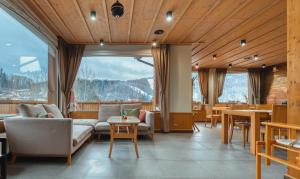 a living room with a couch and chairs and tables at Resort Levočská Dolina in Levoča