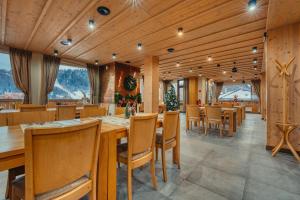 a dining room with wooden walls and tables and chairs at Resort Levočská Dolina in Levoča