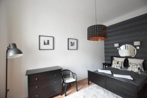 a bedroom with a bed and a desk and a chair at Luxury Apartment by Hi5-Városház Suite in Budapest