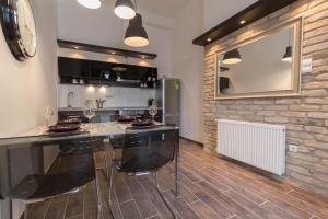 a kitchen with a large black island in a room at Luxury Apartment by Hi5-Városház Suite in Budapest