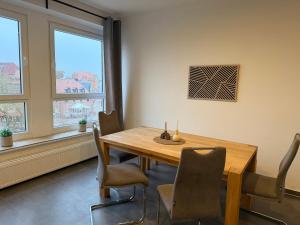 a dining room with a wooden table and chairs at Deck in Cuxhaven