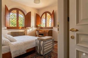 a bedroom with a bed and a desk and a door at VILLA TERRABIANCA - Premium Villas in Tortoreto Lido