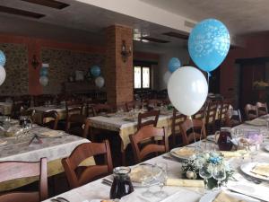 a dining room with tables with balloons on them at Il casolare in Borgia