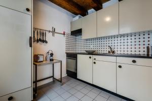 a kitchen with white cabinets and a table in it at Apartment Walhallastrasse in Arbon