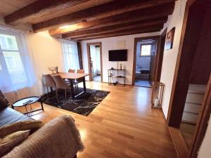 a living room with a table and a couch at Apartment Walhallastrasse in Arbon +2 photos