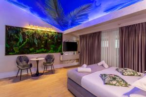 a hotel room with a large aquarium on the wall at Crystal Luxury in Craiova
