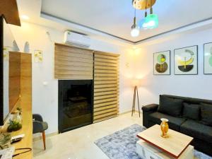 a living room with a couch and a fireplace at Résidence Atlantis F2 avec balcon vue dégagée in Dakar