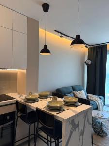 a kitchen with a table with plates on it at SEAFRONT 1BDR, Panoramic views, central Marina in Limassol +24 photos
