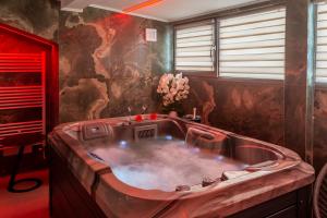 a large bath tub in a room with a red at Crystal Luxury in Craiova +108 photos