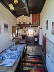 a dining room with a table and a kitchen at Bed and Breakfast Reestdal in Meppel