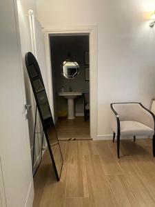a mirror and a chair in a room at Guest house Festinalente in Montegrotto Terme +26 photos
