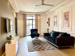 a living room with a couch and a chair at Imaani Homes - 2A at JAK Royale in Apenkwa