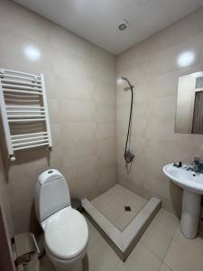a bathroom with a toilet and a sink at Hotel Blue sky in Tbilisi City +61 photos
