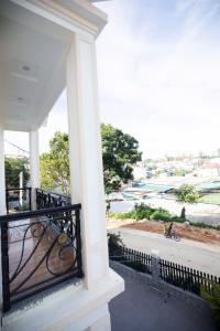 a balcony with a view of the water at HUNA's HOUSE in Da Thanh