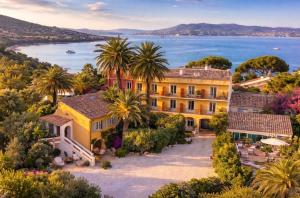 an aerial view of a house with palm trees at La Bastide Du Port - Hôtel de Charme in Saint-Tropez