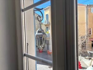 a window with a view of a street view at L'Ecrin Léopold - Centre ville in Montélimar