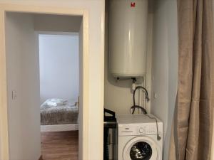 a kitchen with a washer and dryer in a room at L'Ecrin Léopold - Centre ville in Montélimar