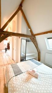 a bedroom with a bed with two towels on it at RR4 - Penthouse in Antwerp