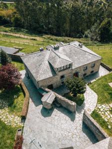an aerial view of a large stone house at Apartamentos A Retoral in Coaña