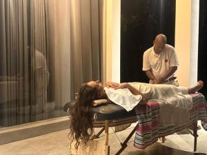 a woman laying on a bed in a room at Willow Waters in Galle