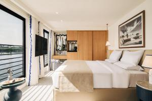 a bedroom with a large bed and a large window at Mazaj Meroot Dahabiya - Every Monday from Luxor in Luxor