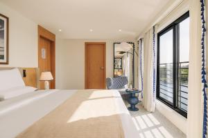 a bedroom with a bed and a large window at Mazaj Meroot Dahabiya - Every Monday from Luxor in Luxor