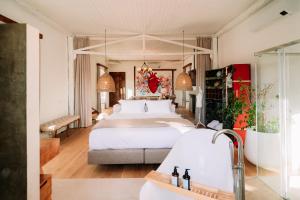 a hotel room with a bed and a bath tub at Herdade dos Moreiros in Arronches