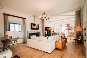 a living room with a white couch and a fireplace at Herdade dos Moreiros in Arronches