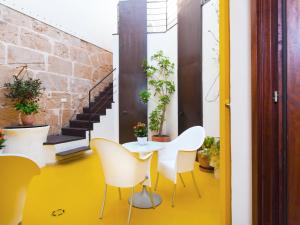 a room with a table and chairs and stairs at Cas Ferrer Nou Hotelet in Alcudia