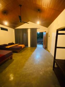 an empty room with two beds and a ceiling at Villu Trails Wilpattu in Wilpattu