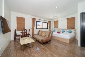 a hotel room with a bed and a couch at Rawai 3BR Villa Shared Pool near Shops & Dining in Ban Saiyuan (1) +23 photos