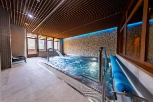 a large indoor swimming pool in a building at Resort Levočská Dolina in Levoča