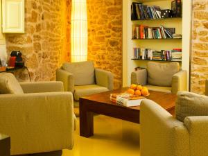 a living room with chairs and a table with fruit on it at Cas Ferrer Nou Hotelet in Alcudia