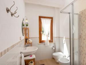 a white bathroom with a sink and a toilet at La Terrazza del Conero La Ginestra in Sirolo