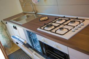 a stove top oven in a kitchen with a sink at La Terrazza del Conero La Ginestra in Sirolo