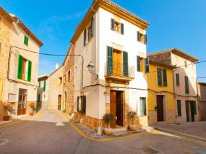 a street in an old town with buildings at Cas Ferrer Nou Hotelet in Alcudia