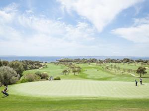 a group of people playing golf on a golf course at Cas Ferrer Nou Hotelet in Alcudia