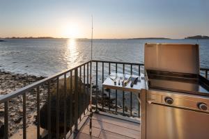 a balcony with a stove and a view of the water at ILE CEZON - Duplex de luxe avec magnifique vue mer in Landéda
