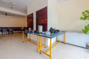 a table in a room with a blue counter at Hotel Ganga Ashoka-Stay By The Ganges At Triveni Ghat in Rishīkesh