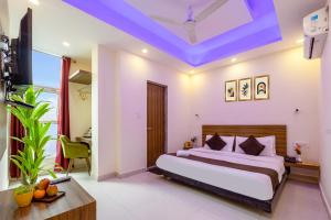 a bedroom with a bed with a blue ceiling at Hotel Ganga Ashoka-Stay By The Ganges At Triveni Ghat in Rishīkesh +89 photos