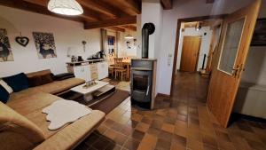 a living room with a couch and a wood stove at Ferienhaus Alexandra in Regen