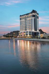 a large building sitting on top of a body of water at Doubletree By Hilton Afyonkarahisar in Afyon