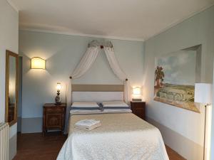 a bedroom with a white bed and two night stands at Villa La Valiana - Full Estate in Montepulciano - HEATED POOL in Valiano +86 photos