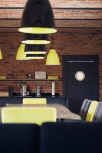 a dining room with a table and yellow chairs at Mak in Murowana Goślina