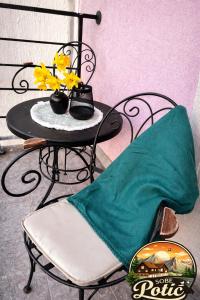 a black table with a chair and flowers on it at Sobe Potić in Belgrade