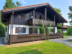 a large wooden house with a large balcony at Ferienhaus Alexandra in Regen