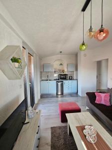 a living room with a couch and a table at Markos Towers Apartments in Prilep