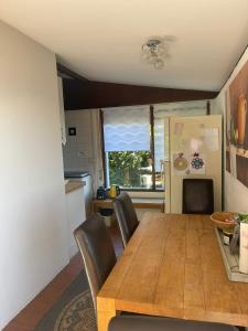 a kitchen and dining room with a wooden table and chairs at Sunclass Tignale Bungalow Gardasee in Tignale